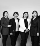 GOBI female leaders standing together in blazers, black and white group portrait against plain backdrop