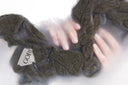 Hand-washing a cashmere sweater in a basin of lukewarm water with mild detergent