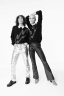 Two models in black lightning-bolt sweaters from the unisex cashmere collection, front view, full-length styling