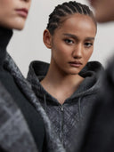 Model wearing gray hooded zip cashmere jacket from the pre-fall cashmere collection, close-up front view