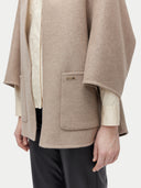 close up of a beige open poncho with a pockets on a white background #color_taupe