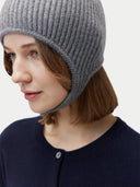 Person wearing a gray knit beanie on a plain background #color_dim-gray