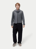 front view of a man wrapped a gray scarf, gray sweater and black pants #color_dim-gray