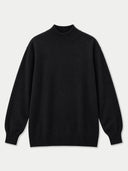 A black long-sleeve knit sweater with a mock neck, ribbed collar, cuffs, and hem, displayed against a light gray background.