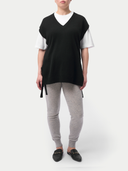 Person wearing a black and white top with gray leggings on a white background #color_dawn-blue