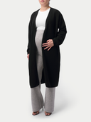 Person wearing a black cardigan over a white top and gray maternity pants on a white background #color_dawn-blue