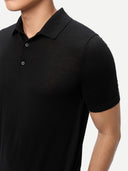 Black polo shirt worn by a person on a light gray background