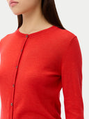close up of a red crew neck cardigan worn by a person on a white background #color_red