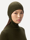 Person wearing an olive green knit beanie and turtleneck against a light gray background #color_avocado