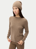 Woman wearing a brown sweater and beanie on a white background #color_taupe