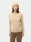 Woman wearing a beige sweater and hat on a white background #color_beige