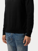 close up of a black sweater and blue jeans #color_black