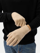 Beige gloves worn by a person against a black background #color_beige