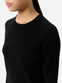 Black crewneck sweater worn by a person on a white background #color_black