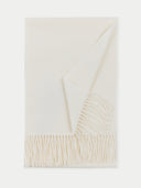 flat lay of a white scarf with fringes on a light gray background. #color_white