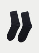 black minimal cashmere sock with a small brand label "GOBI" on a light background #color_black