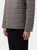close up of a gray puffer jacket and black pants worn by a person on a white background #color_dim-gray