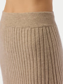 Close-up of a ribbed beige sweater on a plain background #color_warm-grey