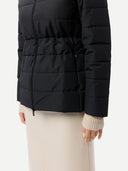close up of a black puffer jacket worn by a person on a white background #color_black