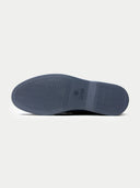 Close-up of a shoe sole with a brand logo on a light gray background #color_steel-gray