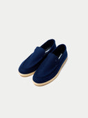 Pair of navy blue loafers on a light gray background #color_navy