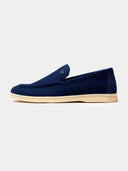 side view of navy blue loafer shoes on a light gray background #color_navy