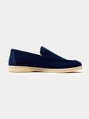 side view of pair of navy loafers on a light gray background