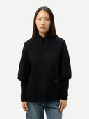 Person wearing a black jacket poncho on a white background #color_black
