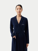 A front view of a person wearing a navy blue, belted cashmere robe with white "NASA" cursive embroidery on the chest, set against a light gray background. #color_default