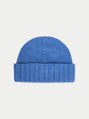 flat lay of a blue beanie on a light gray background #color_blue