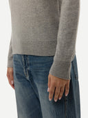 close up of a gray sweater and blue jeans on a white background #color_high-rise