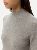 Close-up of a person wearing a gray mock neck sweater on a white background #color_high-rise
