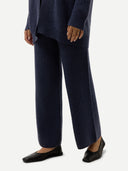 Person wearing a navy outfit with wide-leg pants on a white background #color_crown-blue