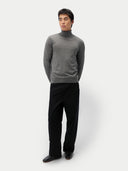 front view of a man wearing a gray turtleneck sweater and black pants on a white background #color_dim-gray