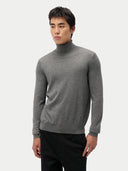 Man wearing a gray turtleneck sweater against a white background #color_dim-gray