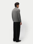 back view of a man wearing a gray turtleneck sweater and black pants on a white background #color_dim-gray