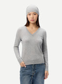 Woman wearing a gray sweater and beanie on a white background #color_high-rise