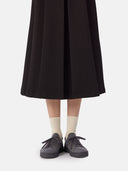 front view of a black skirt and gray knitted sneakers with white socks #color_frost-gray