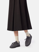 side view of a black skirt and gray knitted sneakers with white socks #color_frost-gray