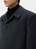 Dark gray coat with a close-up of the collar and buttons on a neutral background #color_charcoal