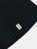 close up of a black rib knit beanie with a small label "GOBI" #color_black