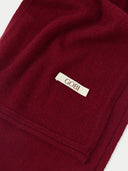 close up of a bordeaux color scarf with a small label "GOBI" #color_bordeaux