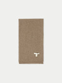 A solid colored cashmere jersey knit scarf in a taupe shade displayed on a plain background. #color_taupe