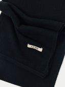 The fabric has a soft, matte texture, and a small, rectangular white brand label with the word "GOBI" in a dark serif font is stitched onto the lower right side. #color_black