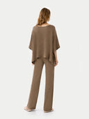 back view of a woman wearing a brown outfit on a white background #color_taupe