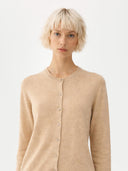 close up front view of a woman wearing a beige cardigan against a white background #color_beige