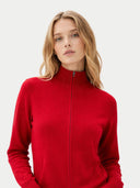Woman wearing a red zip-up sweater on a light gray background #color_chili-pepper