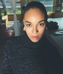 Person wearing a black sparkly sweater indoors