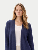 Woman wearing a blue cardigan over a white top on a light gray background #color_crown-blue