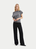 front view of a woman wearing a gray top and black pants on a white background #color_steel-gray